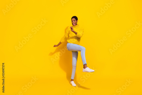 Full length body size view of attractive cheerful skinny girl dancing having fun good mood isolated over bright yellow color background
