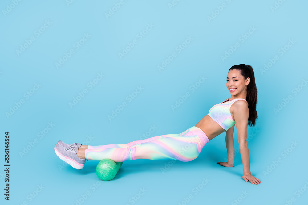 Full size photo of determined lady doing energy crossfit practice wear rainbow print suit isolated blue color background