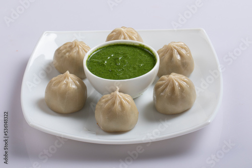 Veg steam momo. Nepalese Traditional dish Momo stuffed with vegetables and then cooked and served with sauce over a rustic wooden background, selective focus