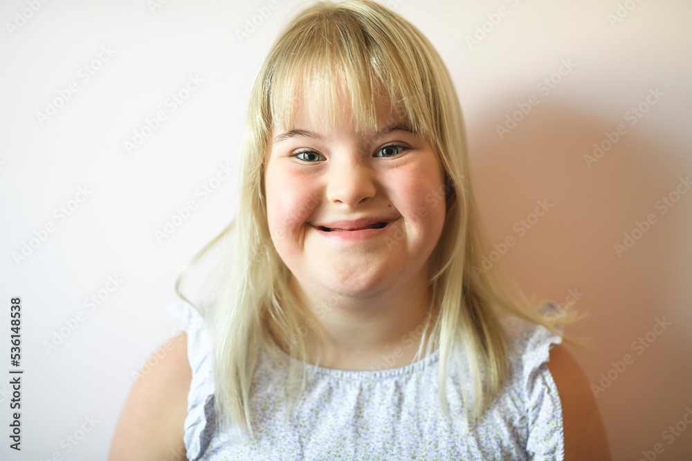 Beautiful little child girl in a dress having great time on her pink bedroom close to the wall Beautiful little child girl in a dress having great time on her pink bedroom close to the wall