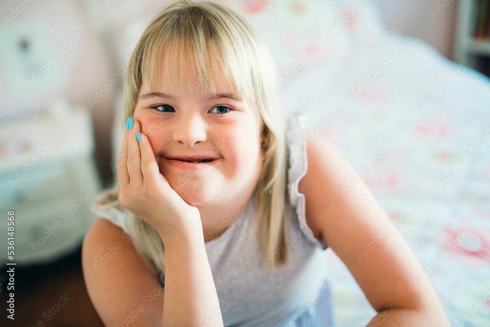 Beautiful little child girl in a dress having great time on her pink bedroom Beautiful little child girl in a dress having great time on her pink bedroom