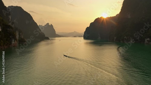 Aerial view drone orbit boat in Cheow Lan lake at sunset, Khao Sok , Thailand photo