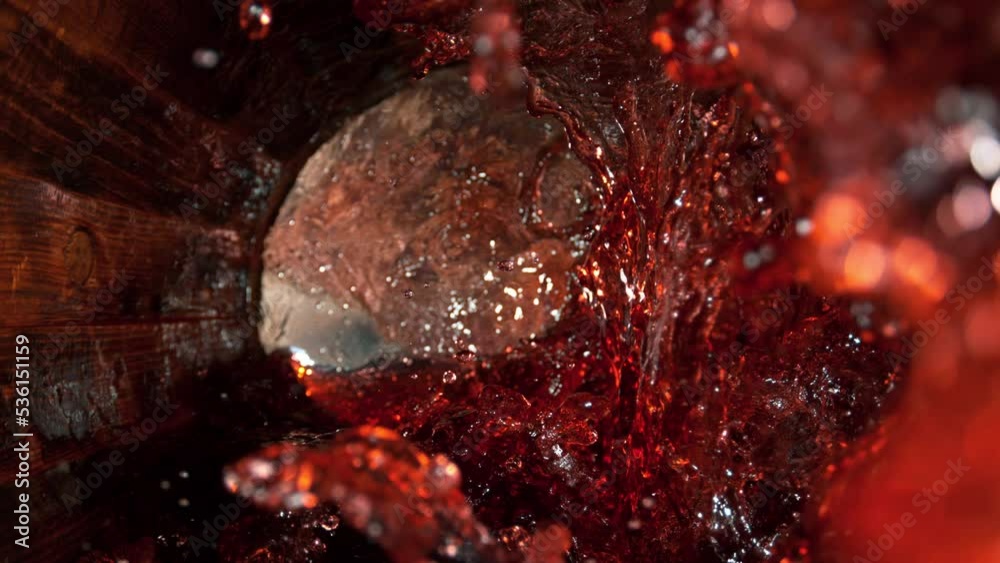 Super Slow Motion Shot of Red Wine Splashing in Old Oak Wooden Barrel at 1000fps. Super Slow Motion Shot of Red Wine Splashing in Old Oak Wooden Barrel at 1000fps.