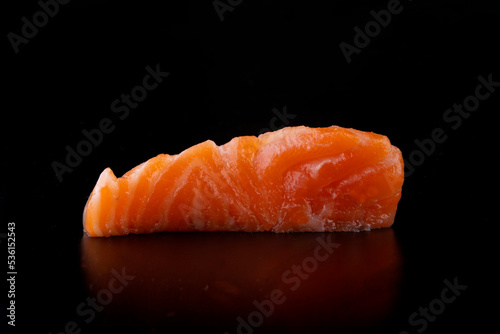 japanese food an isolated piece of salmon sashimi close up macro photo on black background from the front