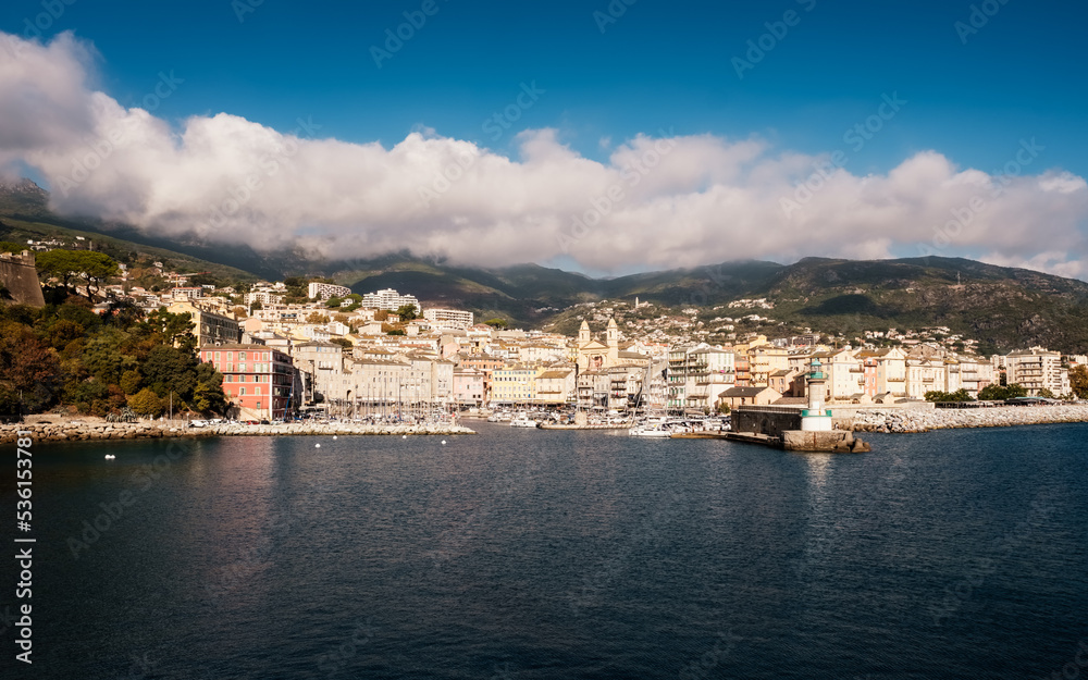 Entrance to the old port and the city of Bastia on the east coast of Corsica with mountains in the distance