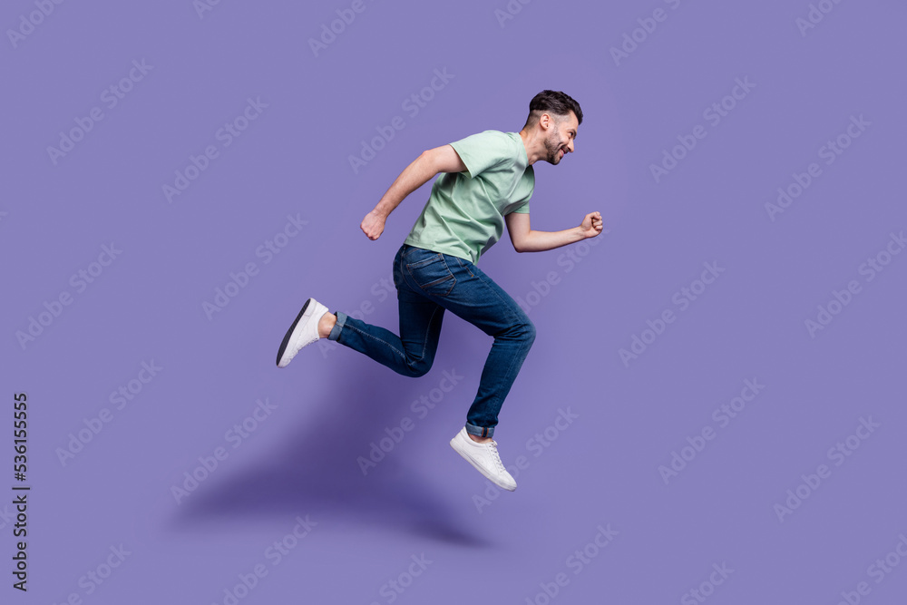 Full length profile side photo of sportive ambitious stylish man move ahead reach dream aim empty space isolated on purple color background