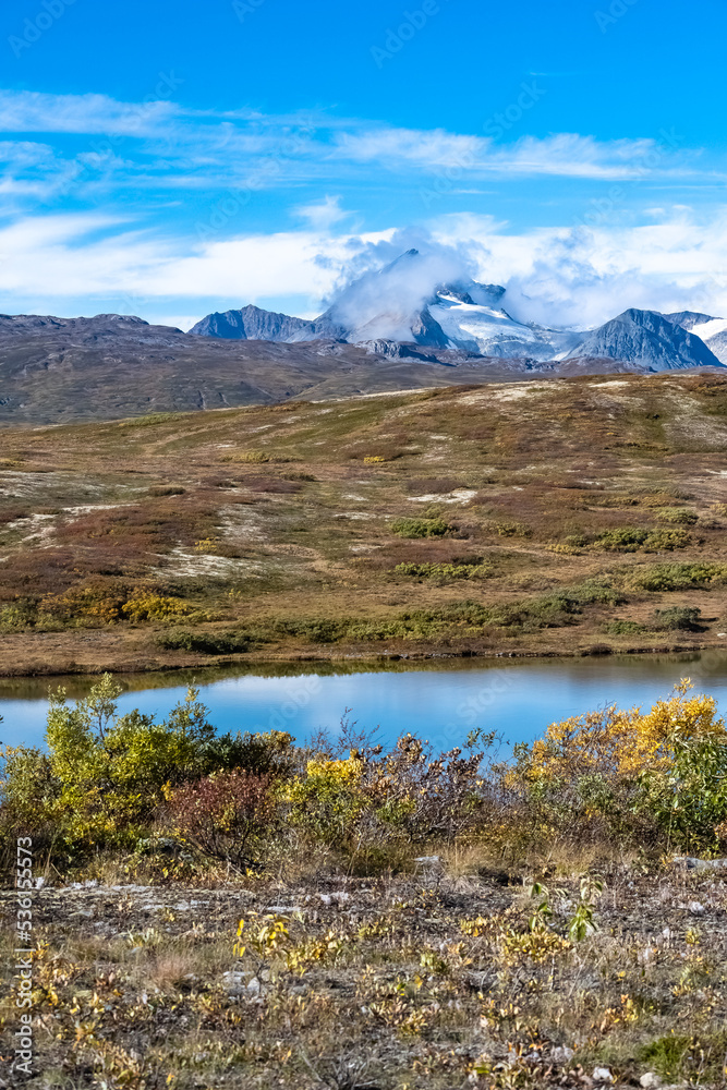 Yukon in Canada, mountains, wild landscape in autumn of the Tombstone park, the Dempster Highway, with a lake
