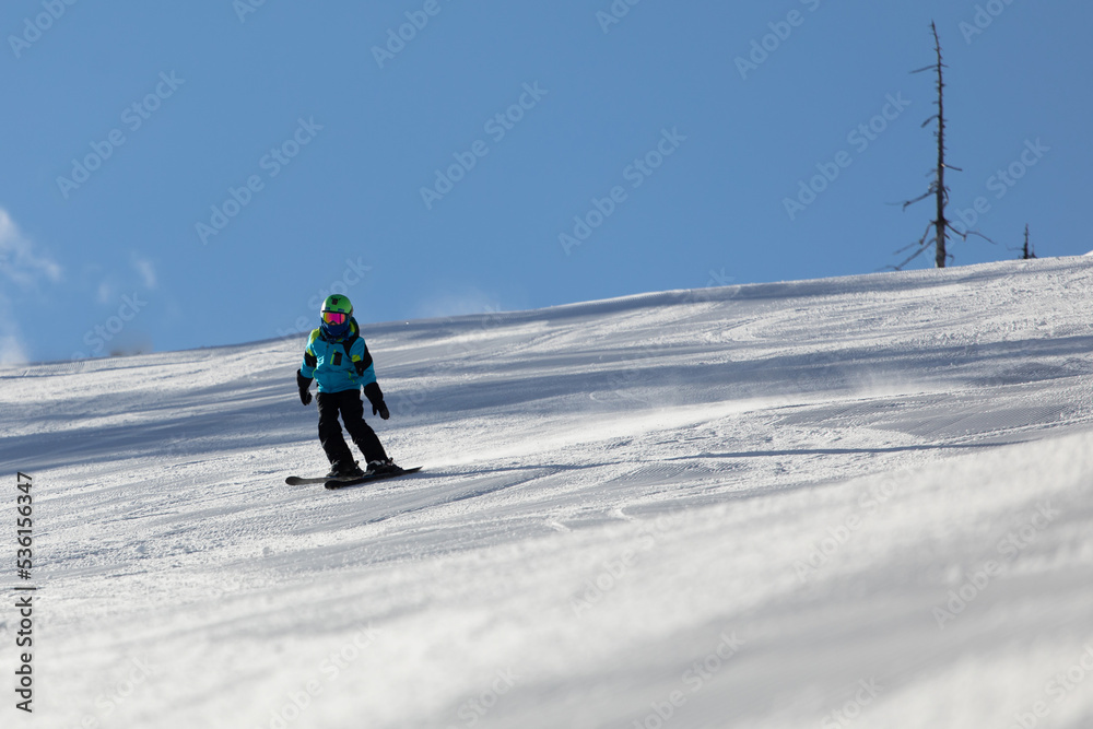 A child while skiing in a ski resort.