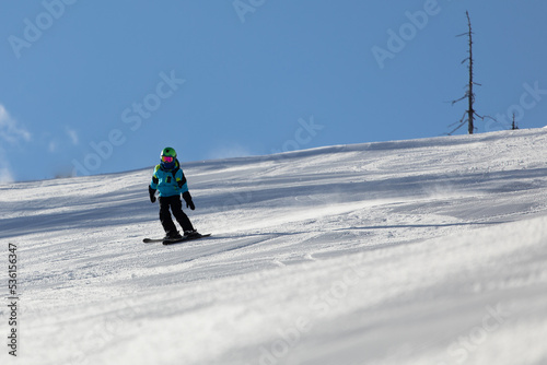 A child while skiing in a ski resort.