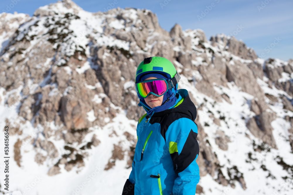 A child while skiing in a ski resort.