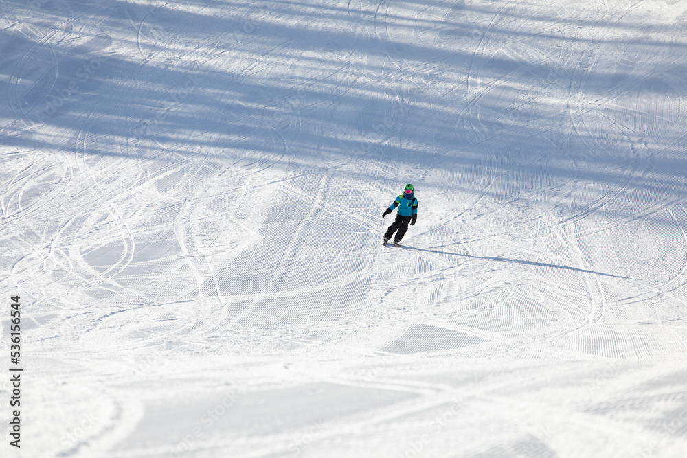 A child while skiing in a ski resort.