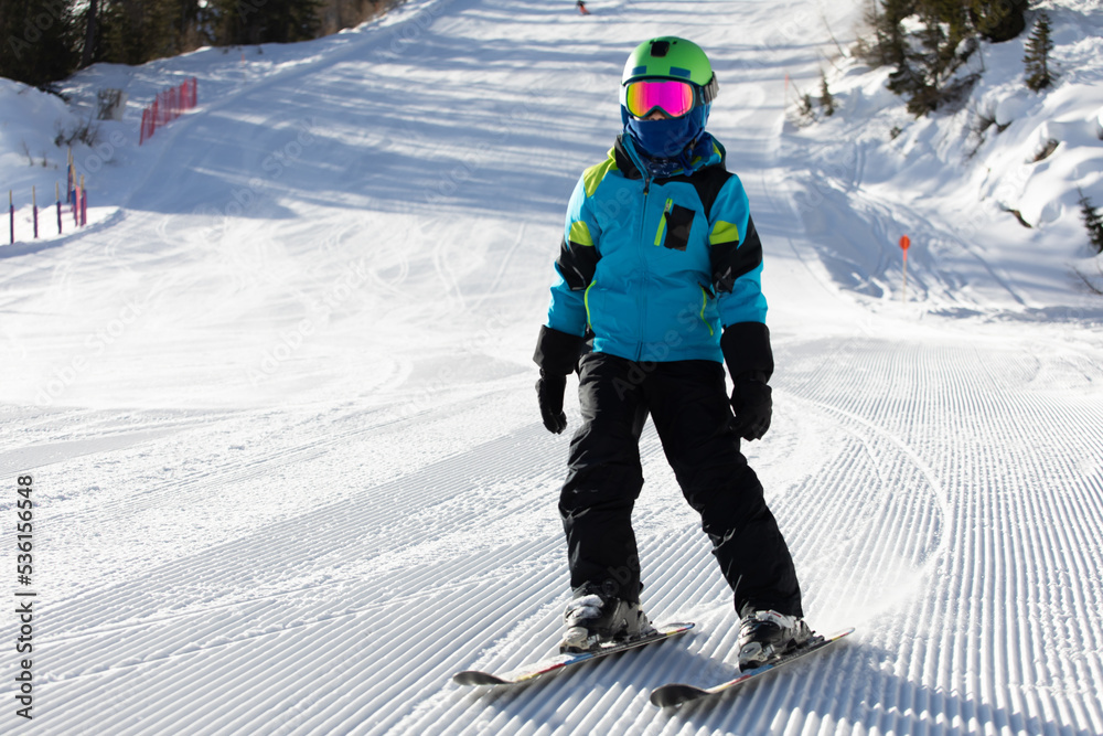 A child while skiing in a ski resort.