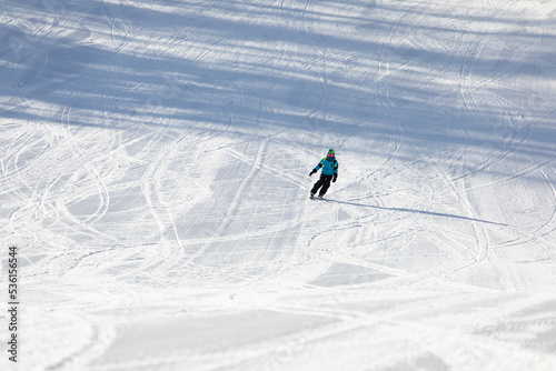 Obraz na płótnie A child while skiing in a ski resort. w salonie