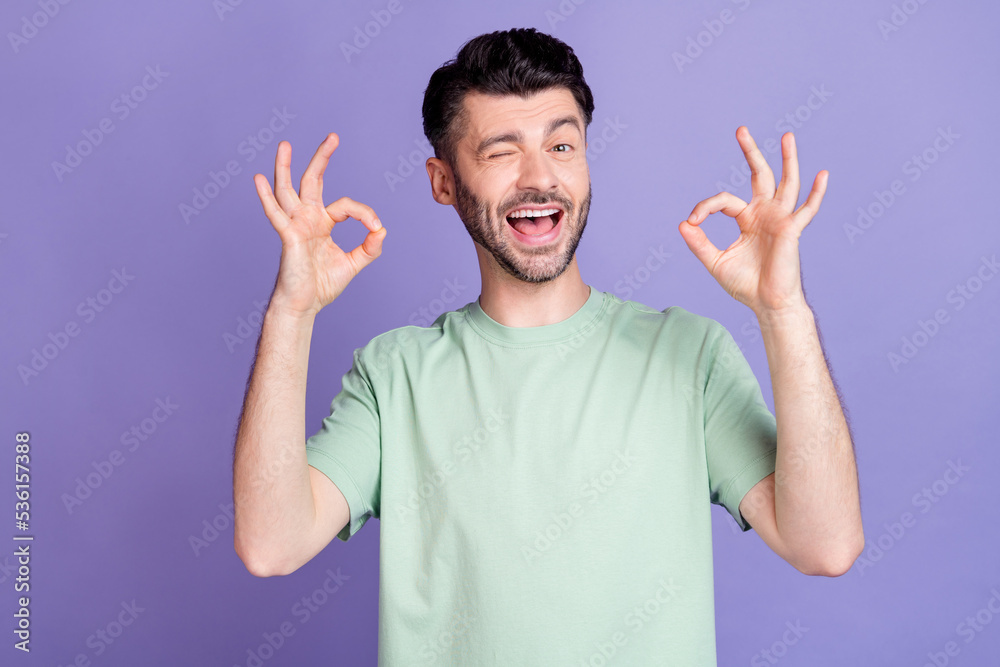Photo of positive cool man arm demonstrate okey symbol recommend quality stylish clothes shop isolated on purple color background Photo of positive cool man arm demonstrate okey symbol recommend quality stylish clothes shop isolated on purple color background