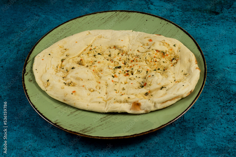 Roghni naan, khamiri roti, kulcha, bread, or chappati served in a dish isolated on background top view Roghni naan, khamiri roti, kulcha, bread, or chappati served in a dish isolated on background top view