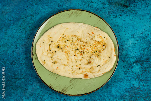 Roghni naan, khamiri roti, kulcha, bread, or chappati served in a dish isolated on background top view photo