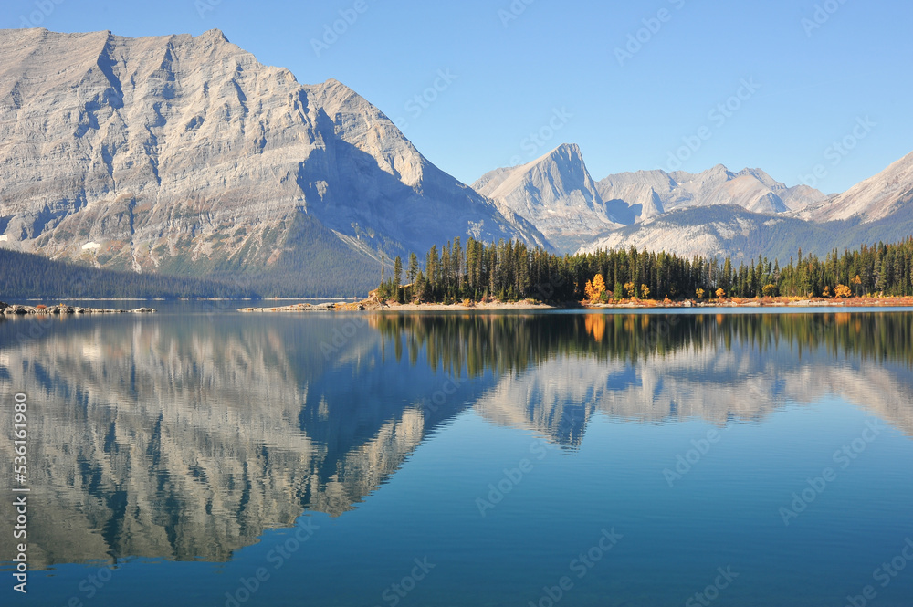 high grey Mountains reflection on lake on fall day