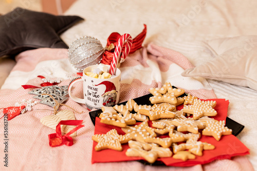 Christmas cookies with Christmas decorations on the bed in the interior