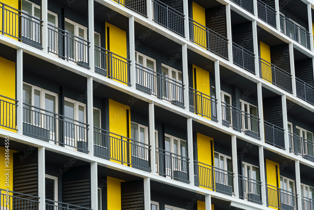 the facade of a modern multistorey building, windows and balconies