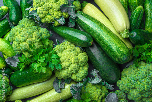 Assortment of ripe green vegetables from broccoli, zucchini and cucumbers. Top view, close-up