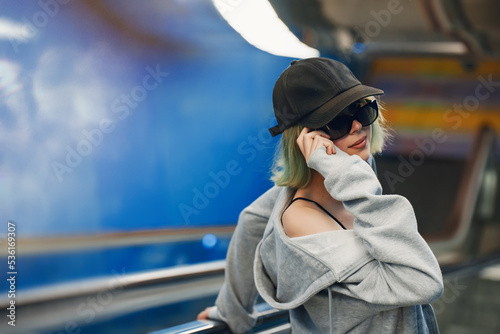 Teenage girl on the escalator in the subway. photo