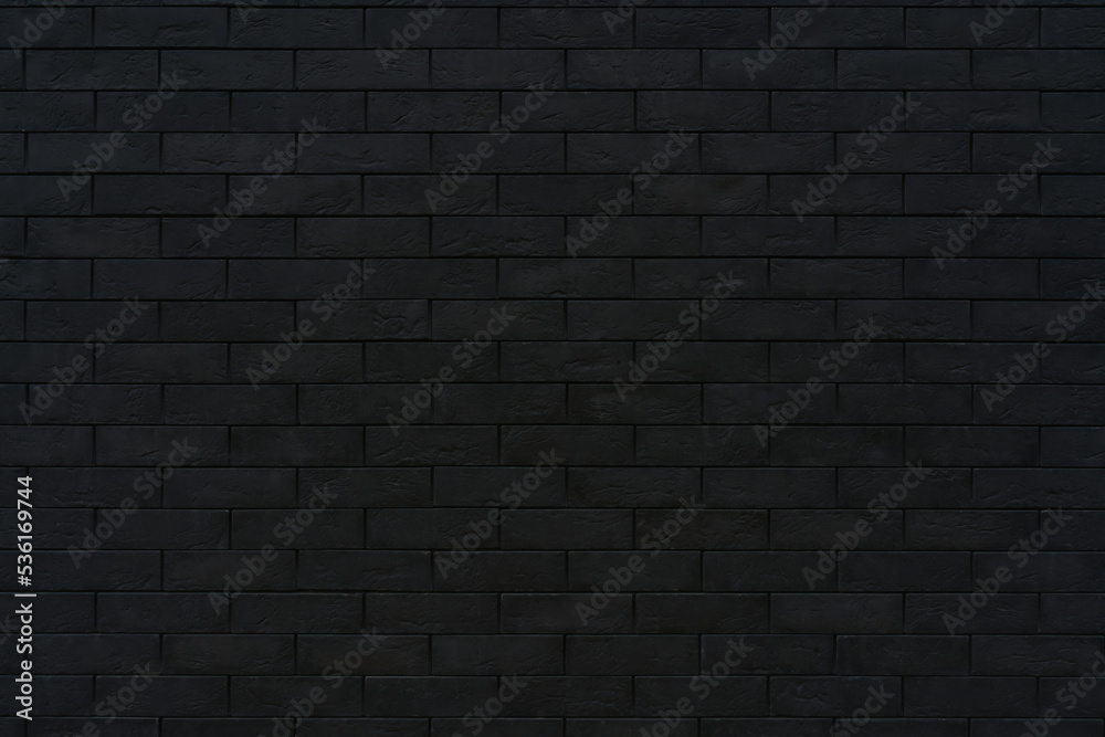 Black brick wall. Dark surface texture. Architectural building background.