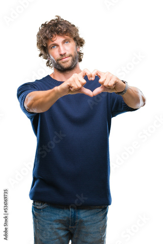 Handsome hispanic model man wearing winter sweater over isolated background smiling in love showing heart symbol and shape with hands. Romantic concept.