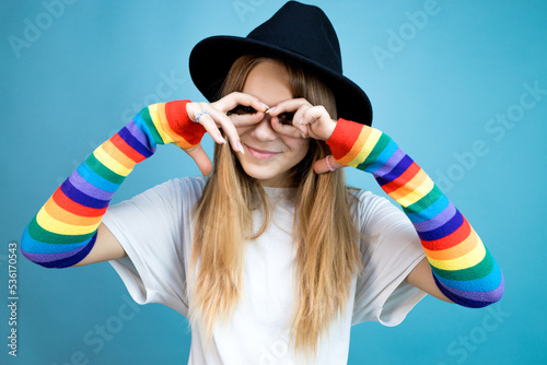 Girl in a hat shows different emotions on a blue background