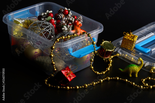 Fotografie Plastic container with New Year and Christmas decorations and toys