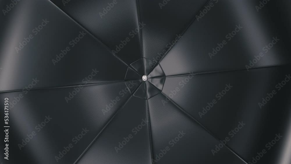 Realistic looping 3D animation of the spinning black umbrella or parasol rendered in UHD as motion background