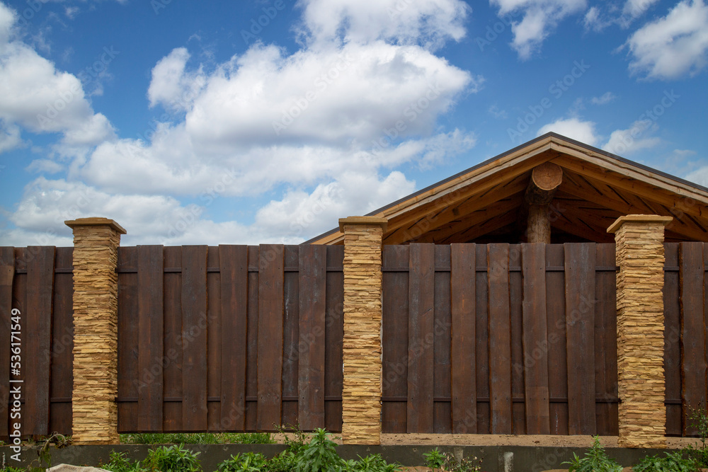 Modern fence around the house.Design and architecture of a modern house. Modern fence around the house.Design and architecture of a modern house.