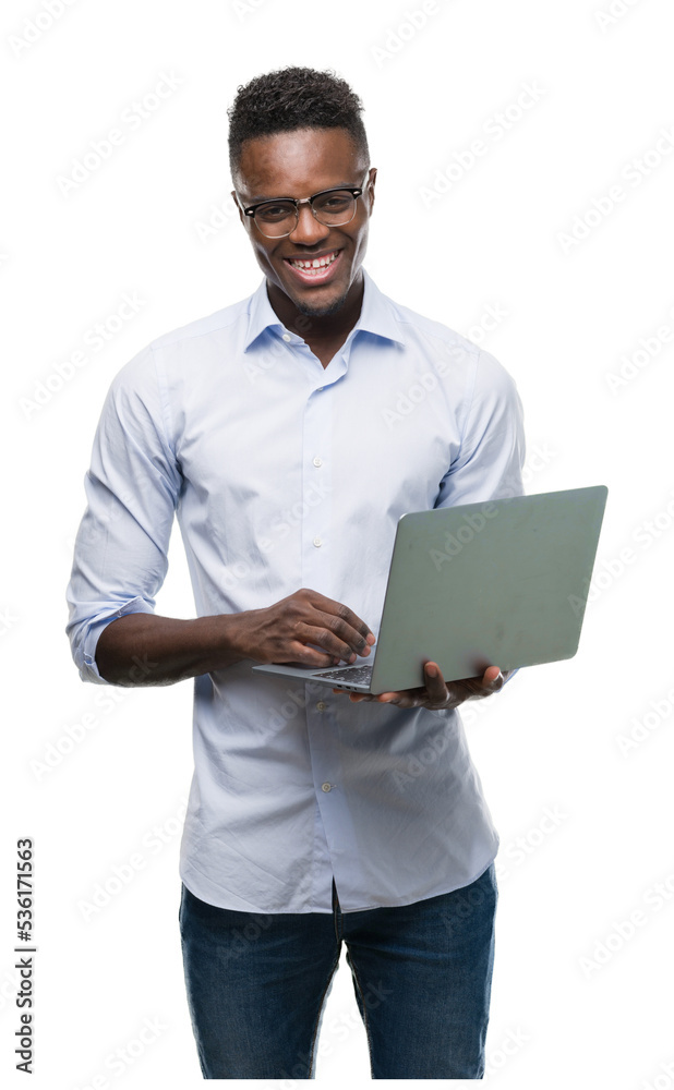 Young african american businessman using computer laptop with a happy face standing and smiling with a confident smile showing teeth