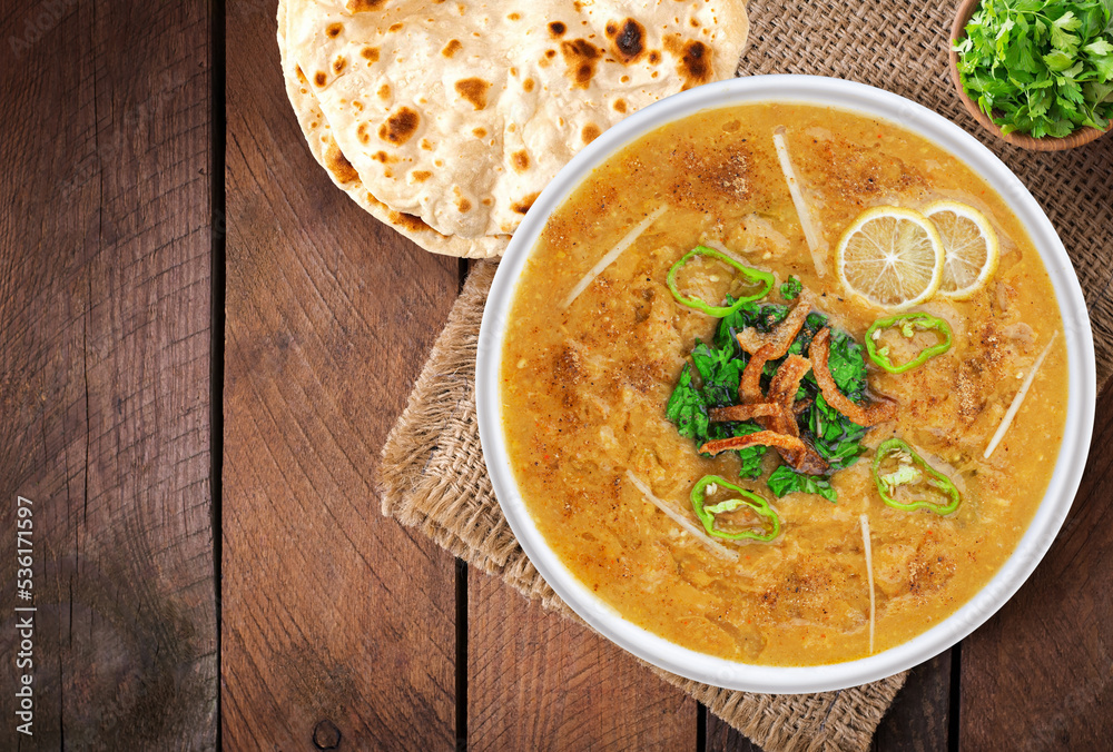 Top View Of Beef Haleem with naan, wood background. Stock Photo Adobe