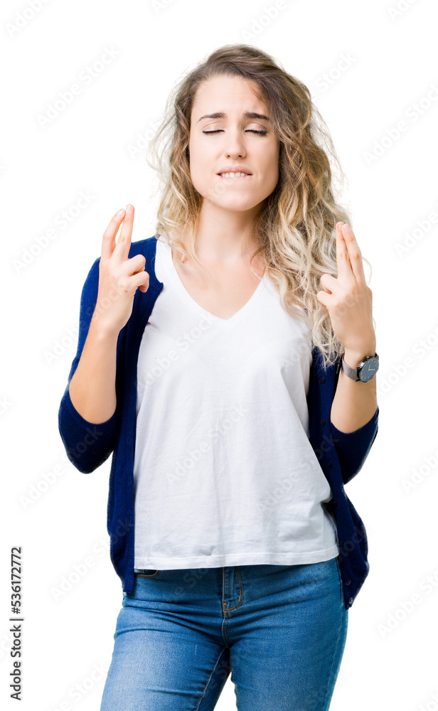 Beautiful young blonde woman over isolated background smiling crossing fingers with hope and eyes closed. Luck and superstitious concept. Beautiful young blonde woman over isolated background smiling crossing fingers with hope and eyes closed. Luck and superstitious concept.
