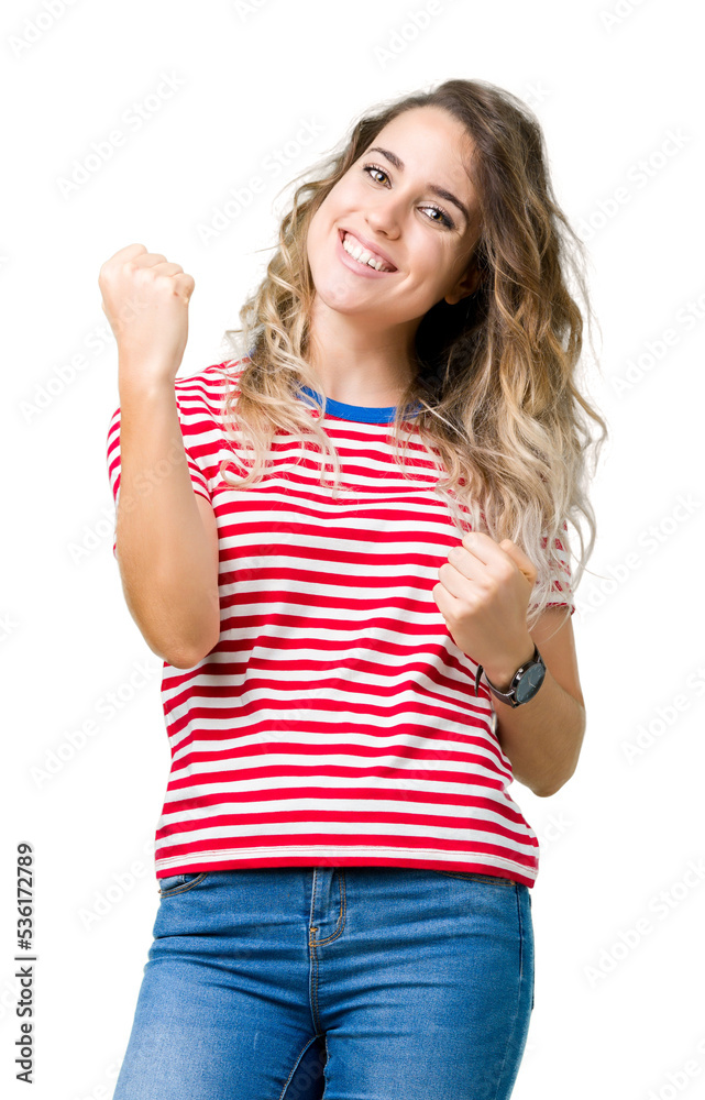 Beautiful young blonde woman over isolated background very happy and excited doing winner gesture with arms raised, smiling and screaming for success. Celebration concept. Beautiful young blonde woman over isolated background very happy and excited doing winner gesture with arms raised, smiling and screaming for success. Celebration concept.