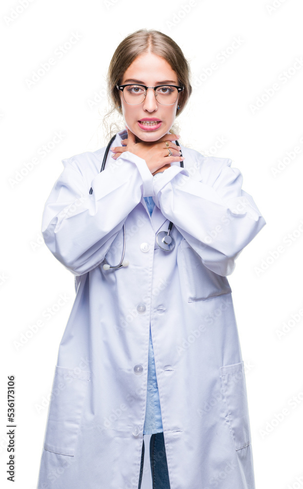 Beautiful young blonde doctor woman wearing medical uniform over isolated background shouting and suffocate because painful strangle. Health problem. Asphyxiate and suicide concept. Beautiful young blonde doctor woman wearing medical uniform over isolated background shouting and suffocate because painful strangle. Health problem. Asphyxiate and suicide concept.