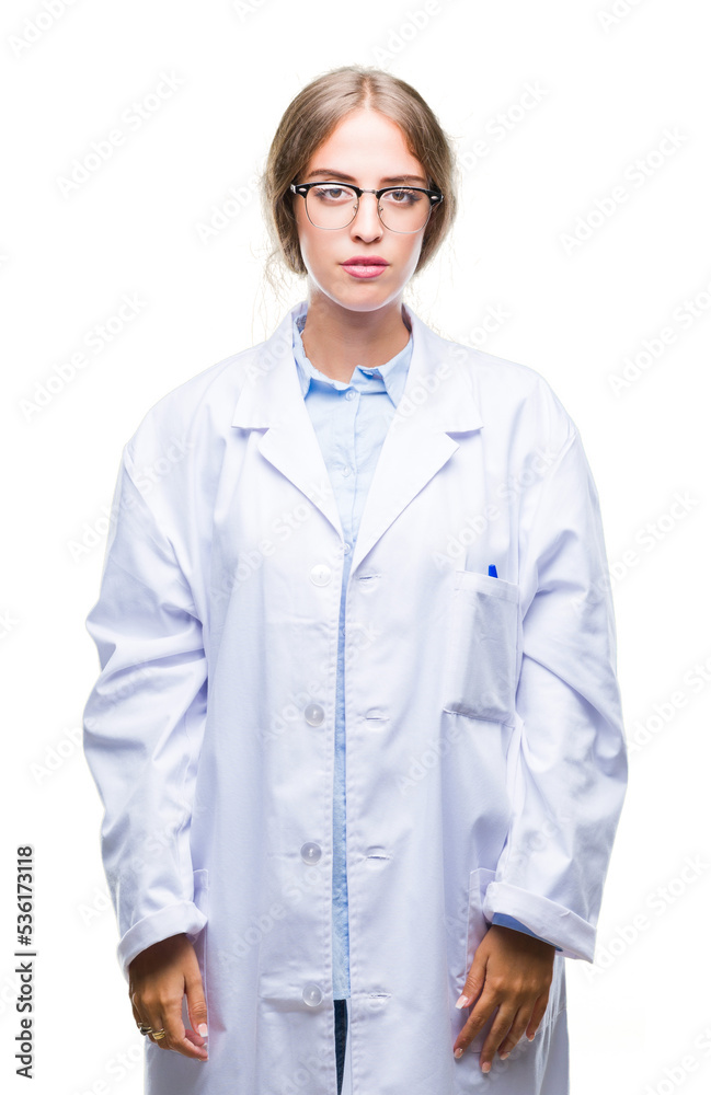Beautiful young blonde doctor woman wearing white coat over isolated background with serious expression on face. Simple and natural looking at the camera. Beautiful young blonde doctor woman wearing white coat over isolated background with serious expression on face. Simple and natural looking at the camera.