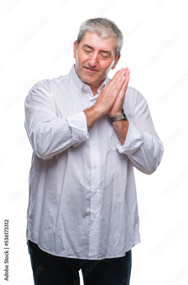 Handsome senior man over isolated background sleeping tired dreaming and posing with hands together while smiling with closed eyes. Handsome senior man over isolated background sleeping tired dreaming and posing with hands together while smiling with closed eyes.