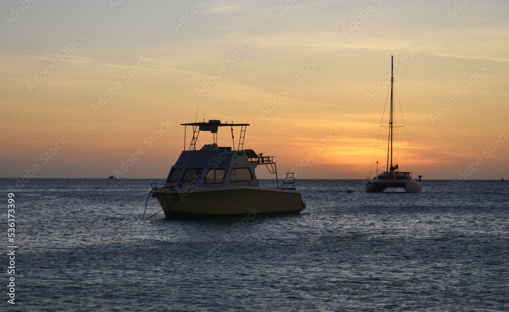 boats and a beautiful sunset on the happy island of Aruba