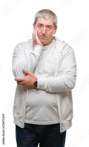 Handsome senior man wearing sport clothes over isolated background thinking looking tired and bored with depression problems with crossed arms. © Krakenimages.com