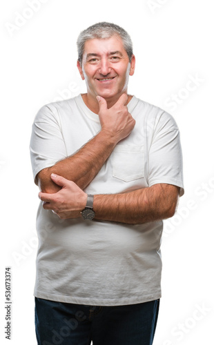 Handsome senior man over isolated background looking confident at the camera with smile with crossed arms and hand raised on chin. Thinking positive. © Krakenimages.com
