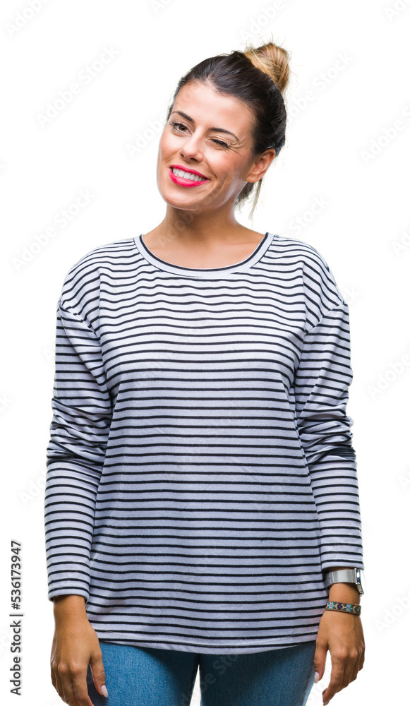 Young beautiful woman casual stripes sweater over isolated background winking looking at the camera with sexy expression, cheerful and happy face. Young beautiful woman casual stripes sweater over isolated background winking looking at the camera with sexy expression, cheerful and happy face.
