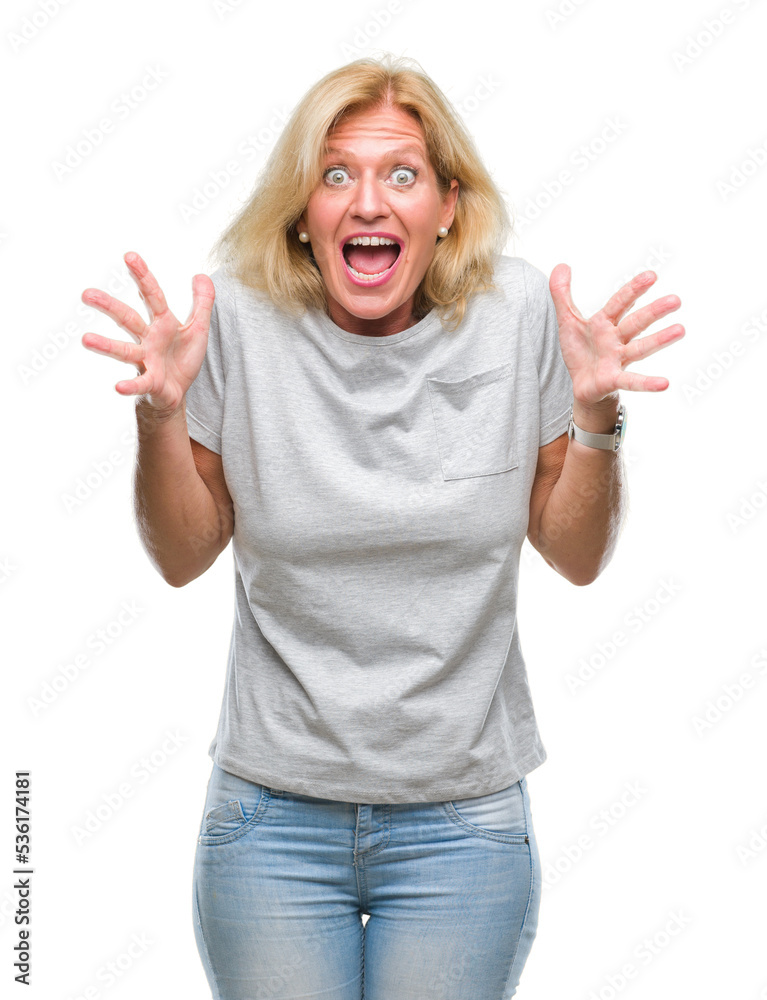 Middle age blonde woman over isolated background celebrating crazy and amazed for success with arms raised and open eyes screaming excited. Winner concept
