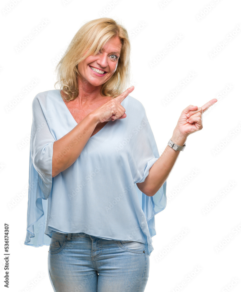 Middle age blonde business woman over isolated background smiling and looking at the camera pointing with two hands and fingers to the side. Middle age blonde business woman over isolated background smiling and looking at the camera pointing with two hands and fingers to the side.