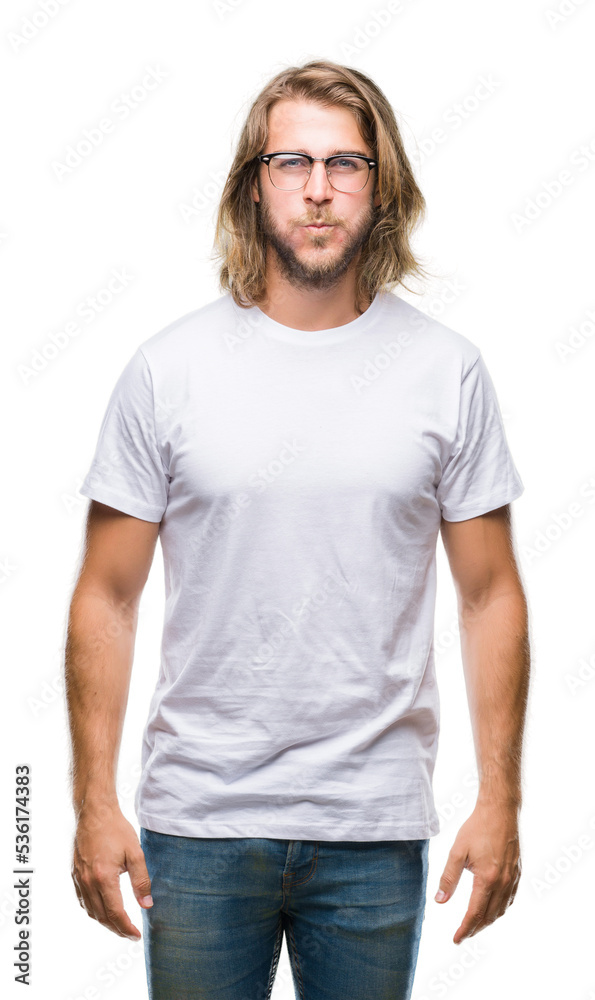 Fototapeta premium Young handsome man with long hair wearing glasses over isolated background puffing cheeks with funny face. Mouth inflated with air, crazy expression.