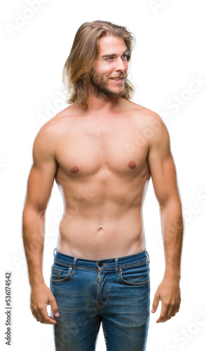Young handsome shirtless man with long hair showing sexy body over isolated background smiling looking side and staring away thinking.