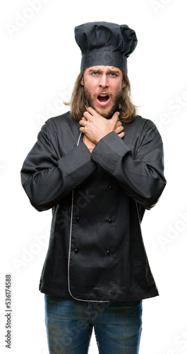 Young handsome cook man with long hair over isolated background shouting and suffocate because painful strangle. Health problem. Asphyxiate and suicide concept. © Krakenimages.com