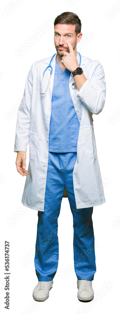 Handsome doctor man wearing medical uniform over isolated background Pointing to the eye watching you gesture, suspicious expression Handsome doctor man wearing medical uniform over isolated background Pointing to the eye watching you gesture, suspicious expression