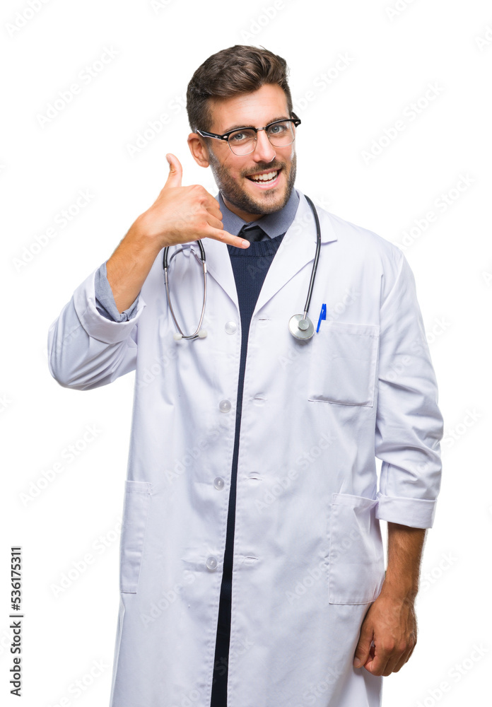 Young handsome doctor man over isolated background smiling doing phone gesture with hand and fingers like talking on the telephone. Communicating concepts. Young handsome doctor man over isolated background smiling doing phone gesture with hand and fingers like talking on the telephone. Communicating concepts.