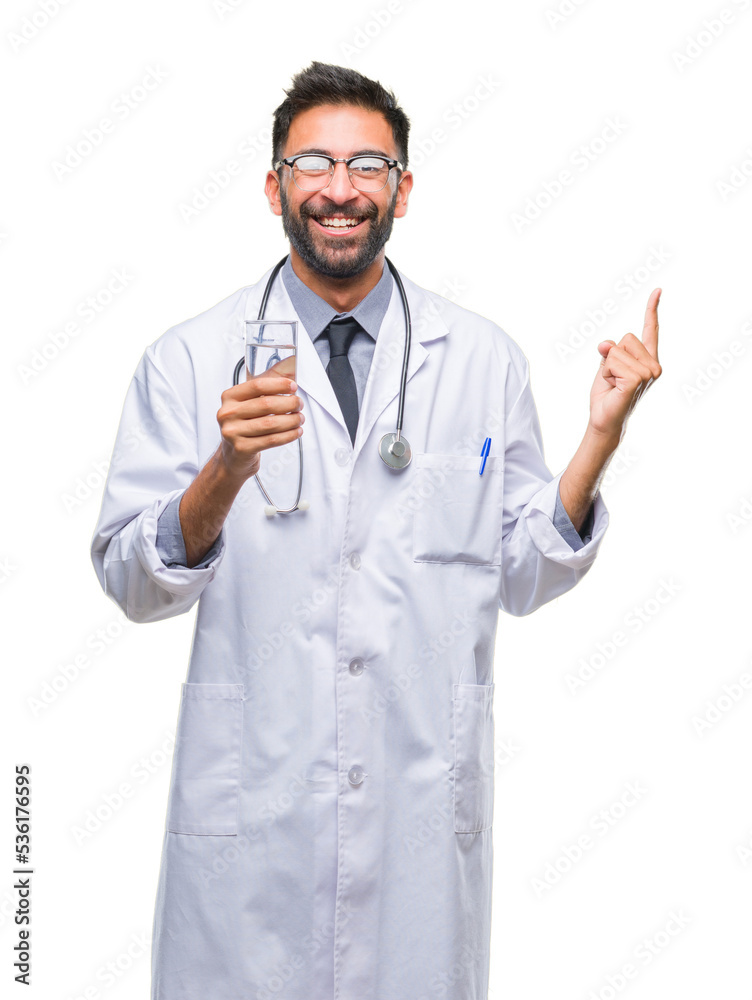 Adult hispanic doctor man drinking glass of water over isolated background very happy pointing with hand and finger to the side Adult hispanic doctor man drinking glass of water over isolated background very happy pointing with hand and finger to the side